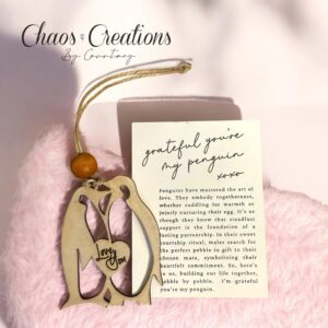 Laser cut penguin ornament paired with a meaningful story card, designed as a sentimental gift symbolizing love, connection, and always finding your person.