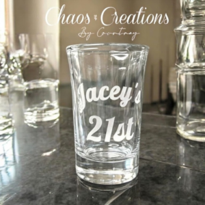 Etched shot glass with custom engraved design on clear glass, personalized for gifts or events