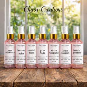 4oz room and linen spray collection displayed on rustic wood surface with bright natural window lighting