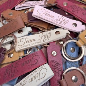 Engraved Team Lily Together We Fight leather-style keychains in assorted colors